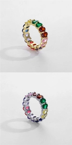 Close-up of rainbow oval-cut zircon rings in gold and silver plating with multi-color stones