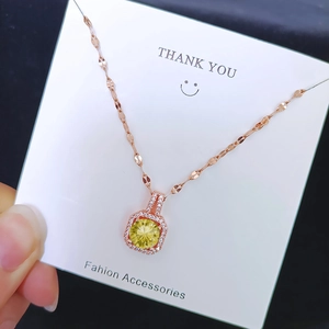 Rose gold necklace with yellow cushion cut zircon pendant and halo diamond setting