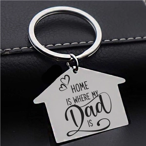 Silver house-shaped keychain engraved with Home is Where My Dad Is on dark leather