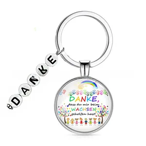 Detail of keychain with 'DANKE' letter beads and rainbow glass charm for gift
