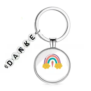 Detailed view of silver keychain with rainbow Schukind pendant and Danke letter beads