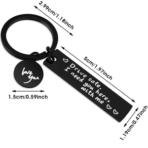 Detailed view of black stainless steel keychain set with white engraved love quotes