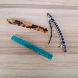 Three acetate spring hair clips in leopard print, marble blue and teal colors