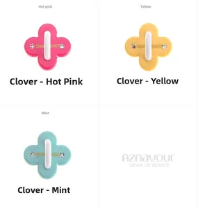 Close-up of cream clover cell phone case hooks with rhinestones in multiple colors