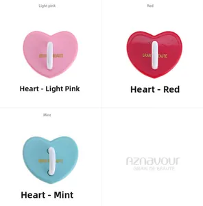 Close-up of heart-shaped accessories in pink, red, and green with golden branding