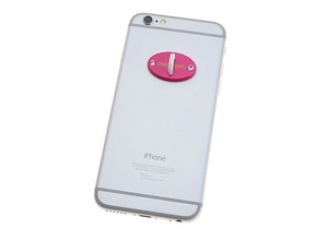 Pink oval phone ring holder with gold text and sparkling rhinestones on silver phone case