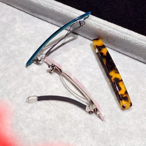 Three acetate hair clips set featuring leopard and marble patterns on a gray display tray