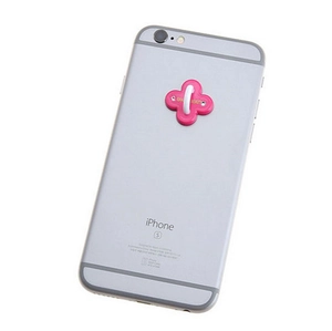 Pink floral phone ring holder accessory with a white loop on a silver smartphone back