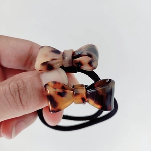 Detail of leopard print bow hair ties set with glossy finish and black elastic bands