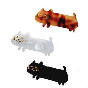 Three acetate cat-shaped hair clips in tortoiseshell, pearl white, and black finishes