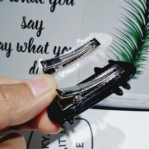 Set of two acetate cat hair clips in black and pearl white with silver metal duckbill base