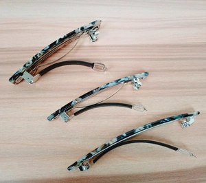 Detailed view of large marble texture spring hair clips with non-slip rubber sleeves