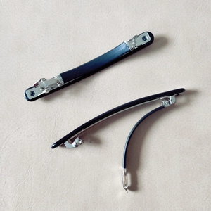 Minimalist black spring hair clips for women shown in closed and open side views