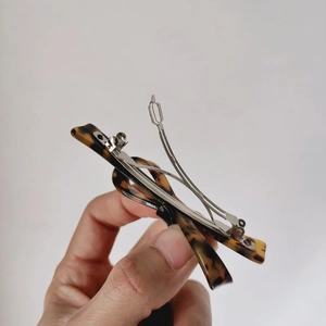 Close-up of tortoise shell leopard print spring hair clip with silver metal fastener