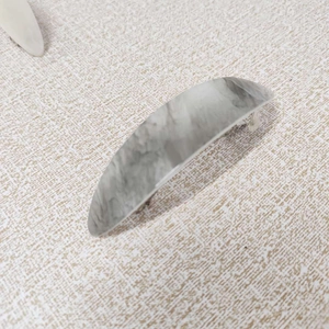 Detail view of French marble pattern hair clip with gray and white acetate finish