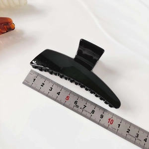 French style glossy black acrylic hair claw clip for women shown with a measuring ruler