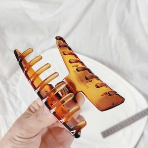 Large amber acrylic hair claw clip with tortoiseshell finish for thick hair styling