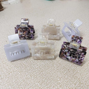Detail view of a six-piece set featuring hollow square hair claws in various elegant textures