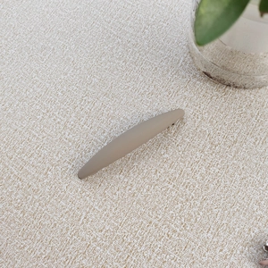 Detail of matte Morandi brown hair clip showing sleek texture on fabric background