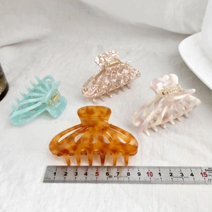 Set of four 9cm acetate hair claws in amber, mint, marble, and pearl finishes
