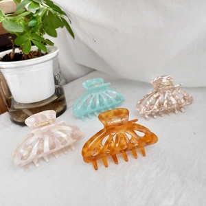 Set of four 9cm acetate hair claws in marble, amber, floral, and mint green colors