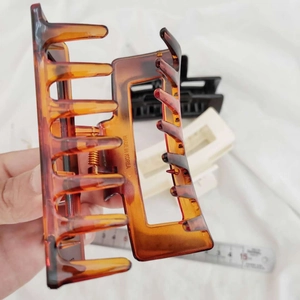 Large square resin hair claws in tortoiseshell and cream colors with size measurement