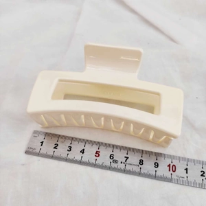 Detail showing the 10.5cm length measurement of the matte cream square hair claw clip
