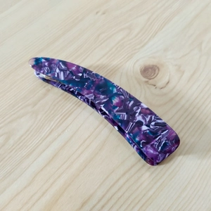 Detail view of purple marble ink pattern on oversized banana hair clip for women