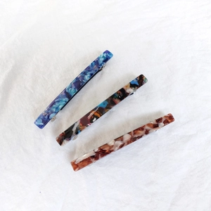 Set of three 8.5cm acetate hair clips in blue floral, marble, and beige patterns