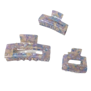 Three sizes of French acetate hair claws with marble purple and yellow patterns