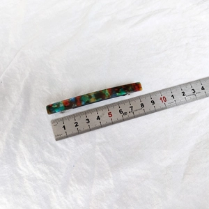 8.5cm colorful tortoiseshell resin hair clip with spring mechanism on white fabric