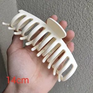Detail shot of a 14cm milky white large hair claw clip for thick hair styling
