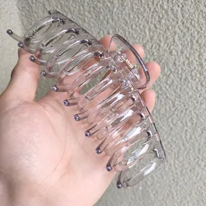 Detail view of a 14cm large translucent purple hair claw clip for thick hair styling