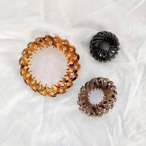 Three-piece bird nest hair clips in amber, black and taupe for buns and ponytails