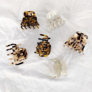 Set of 6 small leopard print and marble white acetate hair claws on linen fabric