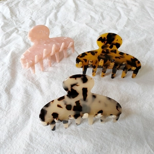 Detailed set of three French acetate hair claws in leopard and marble patterns