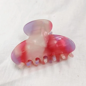 Macro detail of the pink and purple marble texture on this acetate hair claw clip