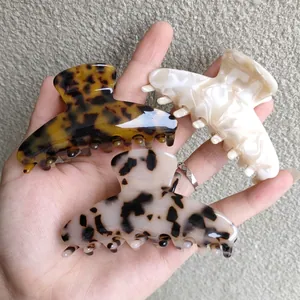 Three-piece acetate hair claw clips in tortoiseshell, cream, and marble patterns