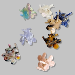 Set of 7 small floral hair clips in assorted colors like tortoise and pearl white