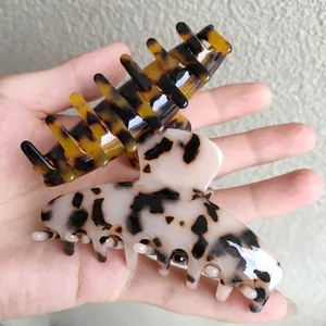 Elegant medium acetate hair claws in tortoise shell and ivory leopard patterns for women