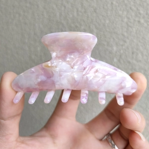 Close-up of marble textured acetate hair claw clip in purple and white tones