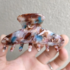 Detail showing the tortoiseshell marble pattern on a medium acetate hair claw clip