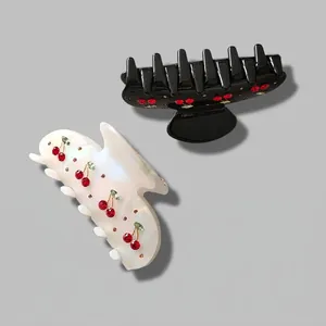 Elegant French style cherry hair claw clips in black and pearl white with red rhinestones