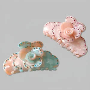 Elegant floral claw clips with sparkling rhinestones in pink and gradient peach-blue