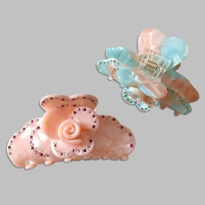 Floral hair claw clips with rhinestones in pink acetate and blue gradient rose designs