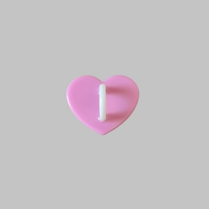 Detailed view of pink heart-shaped phone accessory with a white attachment hook