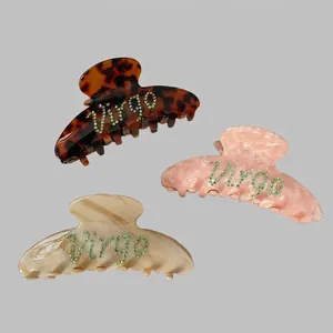 Set of three Virgo zodiac hair claws in tortoise and marble acetate with green rhinestones