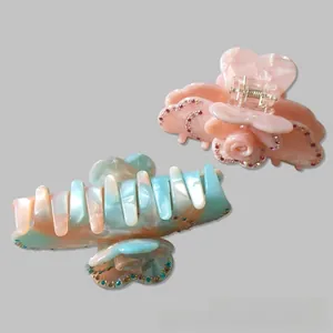 Close-up of floral and marble texture hair clips with sparkling rhinestone embellishments