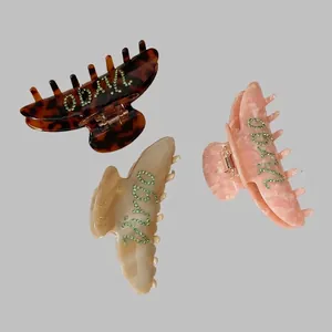 French vintage large hair claw clips set with rhinestone letters and marble texture
