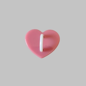 Detail of pink heart-shaped phone accessory with a white plastic hook and 3M adhesive